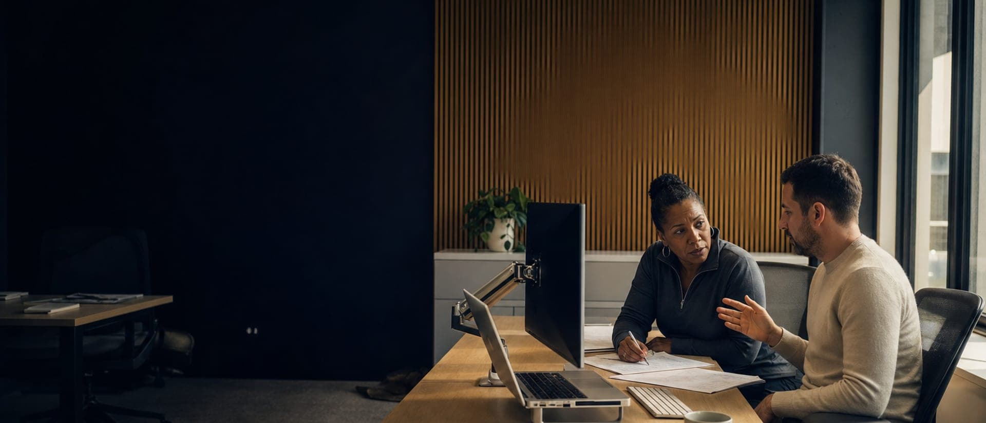 A deal review happening at a desk, not a boardroom